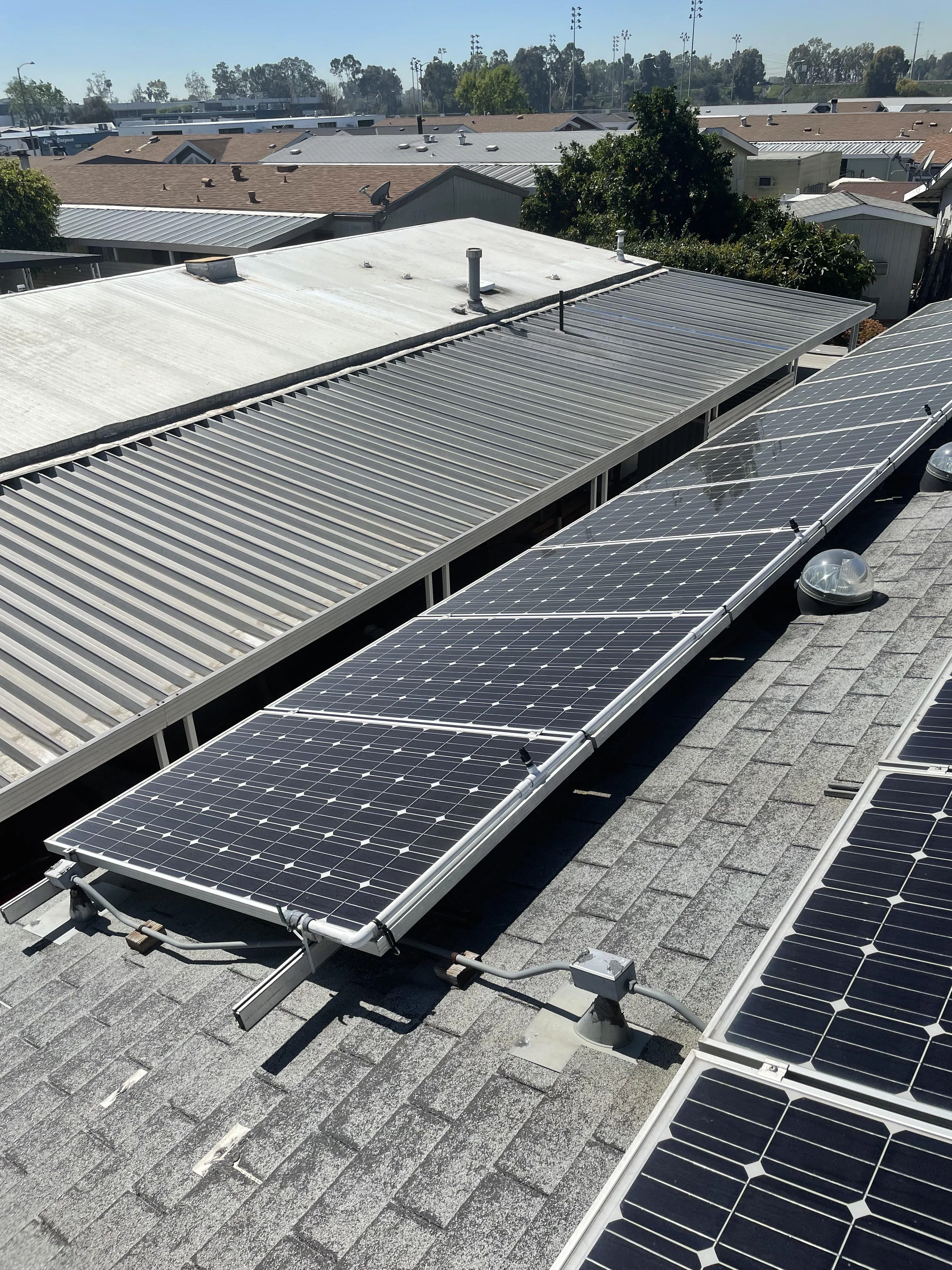 Rooftop solar panel system installed on a manufactured home in Southern California, showcasing energy-efficient design for mobile homeowners.