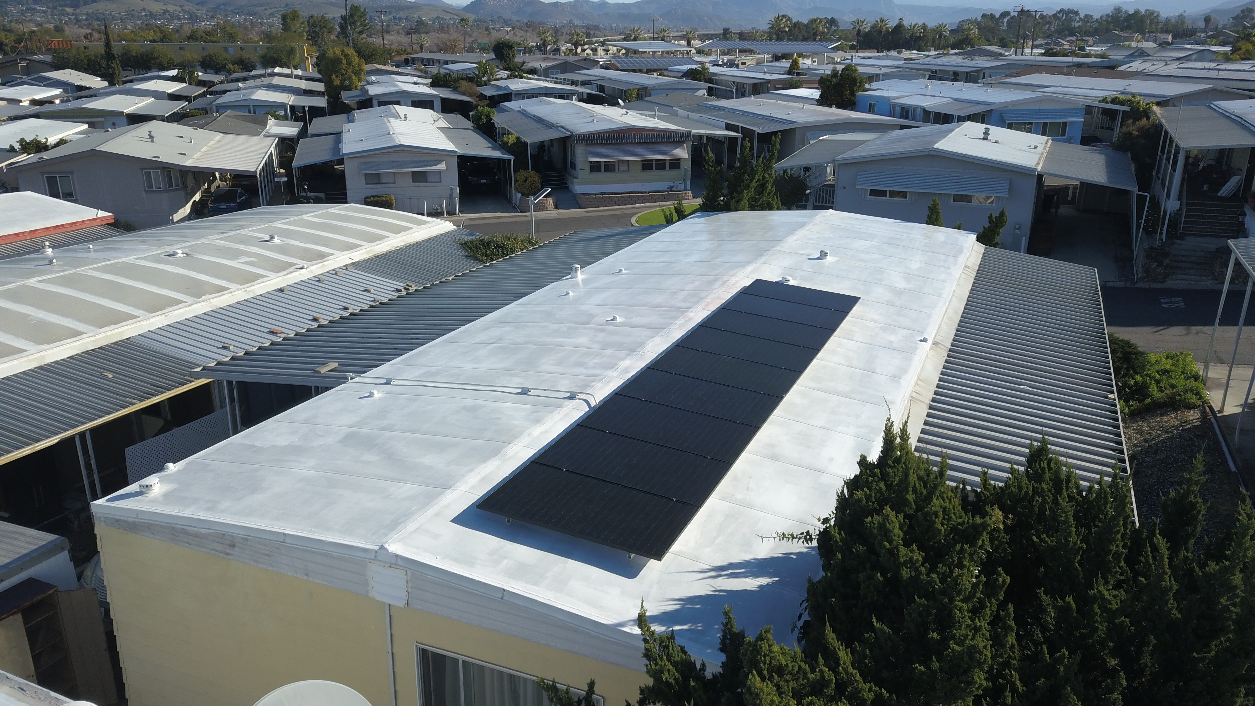 Solar panel installation on a manufactured home rooftop in a residential community, showcasing energy-efficient design and clean energy solutions in Southern California.