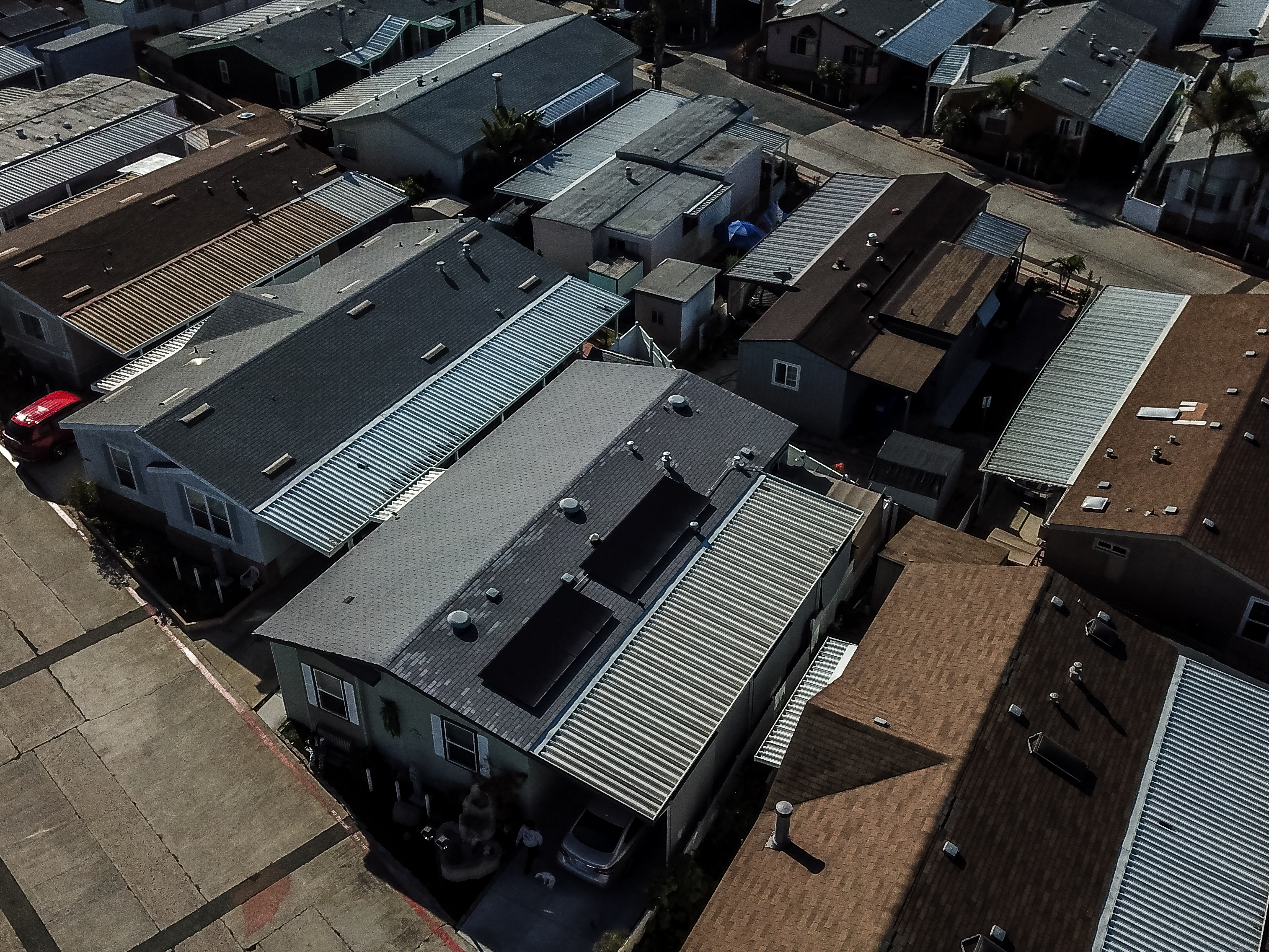 Rooftop solar panel installation on a manufactured home in a mobile home community, showcasing energy-efficient solutions for residential energy needs.